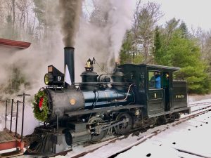 Steam engine pulling into the station in the winter