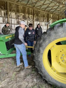 Students looking at a tractor and attachments.