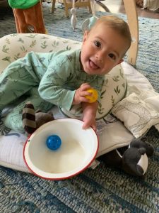 toddler playing the ball in bowl activity