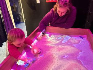 Photo of parent and child using a sensory table