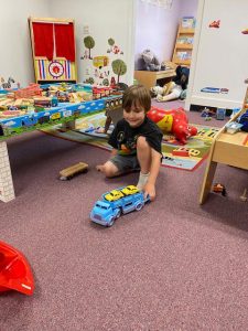 a child playing with a toy truck in the Rumpus Room