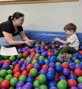 adult and youth in ball pit
