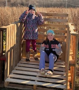 Two members show off the compost bin they made as part of the ag challenge