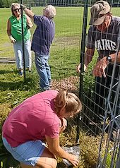 Piscataquis Executive Committee put up fence at school garden