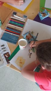 youth drawing with colored pencils