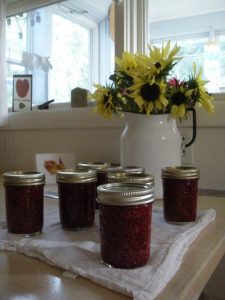 jars of raspberry jam on a kitchen table