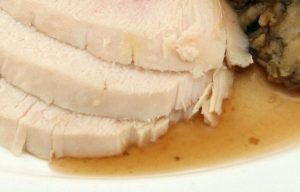 a dish with turkey, stuffing and gravy