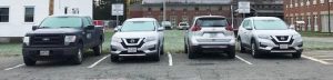 four of Extension's vehicles that staff can reserve in the Libby Hall parking lot