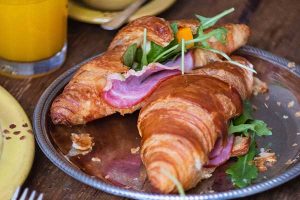 a croissant for breakfast with egg and ham