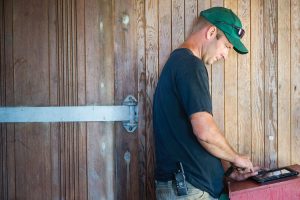 Farmer in barn using a laptop