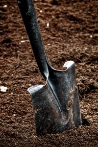 a shovel stuck in dirt