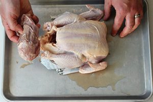 Photo showing removal of giblets from store-bought chicken