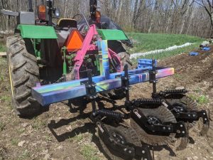 3 wavy coulters trailed by repurposed injector knives attached to tractor