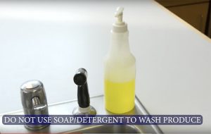 Kitchen sink showing dish soap and message do not use soap/detergent to wash produce.