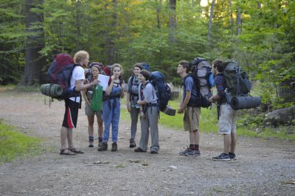 Counselor giving peptalk to hikers