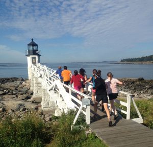L2 campers running towards Marshall Point Light House