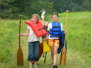 Two girls preparing to canoe
