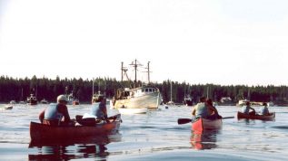 campers canoeing through the harbor