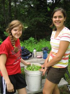 two campers with harvested vegetables