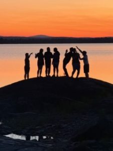 Campers dance at sunset