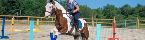4-H member and horse practicing jumping at horse camp