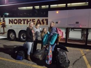 Three 4-H members ready to board bus to ESE