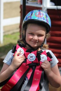 4-H Born to Ride member with event ribbons