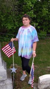 Kelsy putting flags out at the cemetery