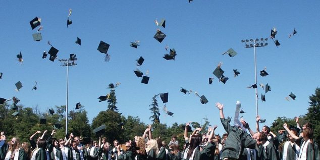 stock image of graduates celebrating after the ceremony - image for home page button for WCEA scholarship