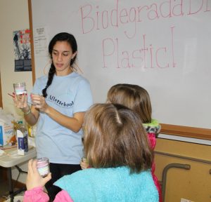 Tina Ferrara, left, shares her knowledge about biodegradable plastic with 4-H members.