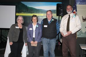 WCEA Secretary Gretchen Cherry (left), presents Ann Luginbuhl, Robert French and David Winski with the University of Maine Volunteer Pen Awards.