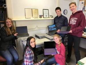 The 4-H Tech Changemakers, left to right, Inez, Mikaila, Paige, Sam and Forrest show off the Surface Pros donated by Microsoft to assist them with their local project focused on addressing food insecurity.