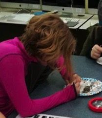 Participant at Jonesboro STEM SPIN Club explores an owl pellet.