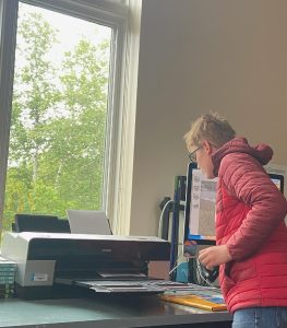 youth explores a printer