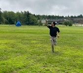 man running flying a kite