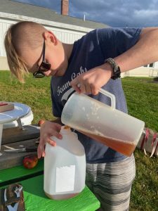 youth pours apple cider