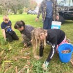 4-H volunteer and youth doing yard clean up