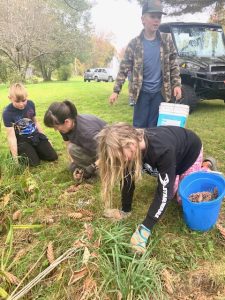 4-H volunteer and youth doing yard clean up