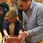 4-H professional shows youth how to use screen printing equipment