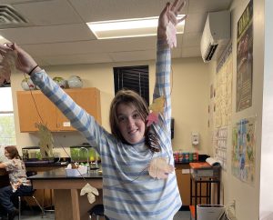 4-H'er with a leaf garland creation.