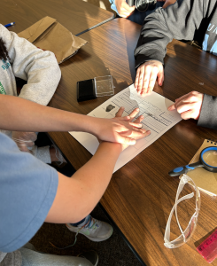 Youth taking their own fingerprints at Forensic Science 4-H Science Friday. 