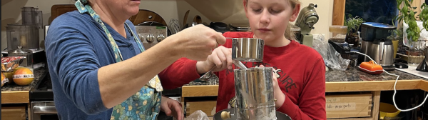 volunteer and youth mixing cookies