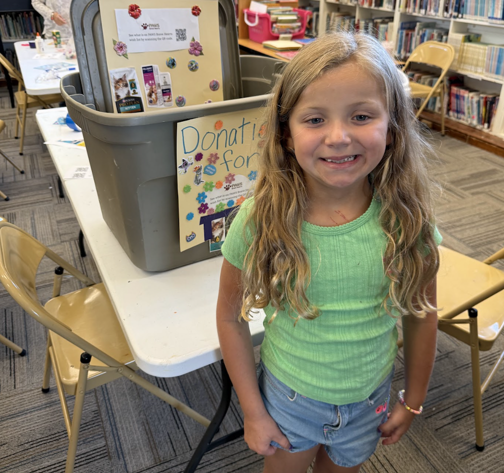 Youth showcases donation box.