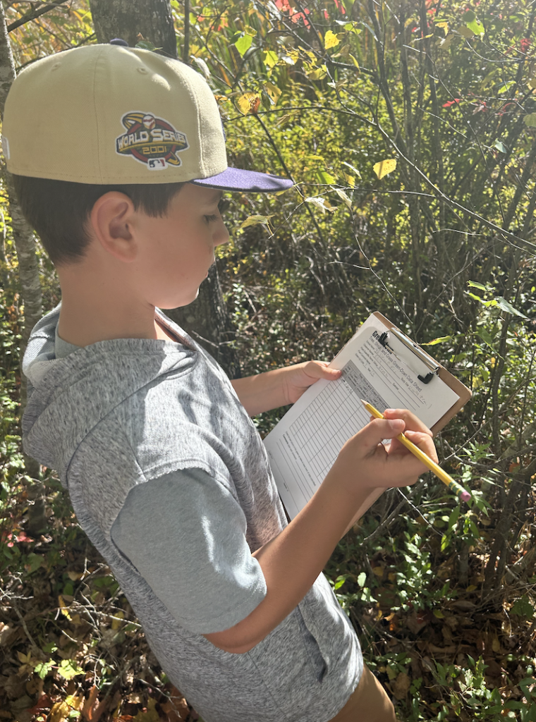 youth outside with a clipboard