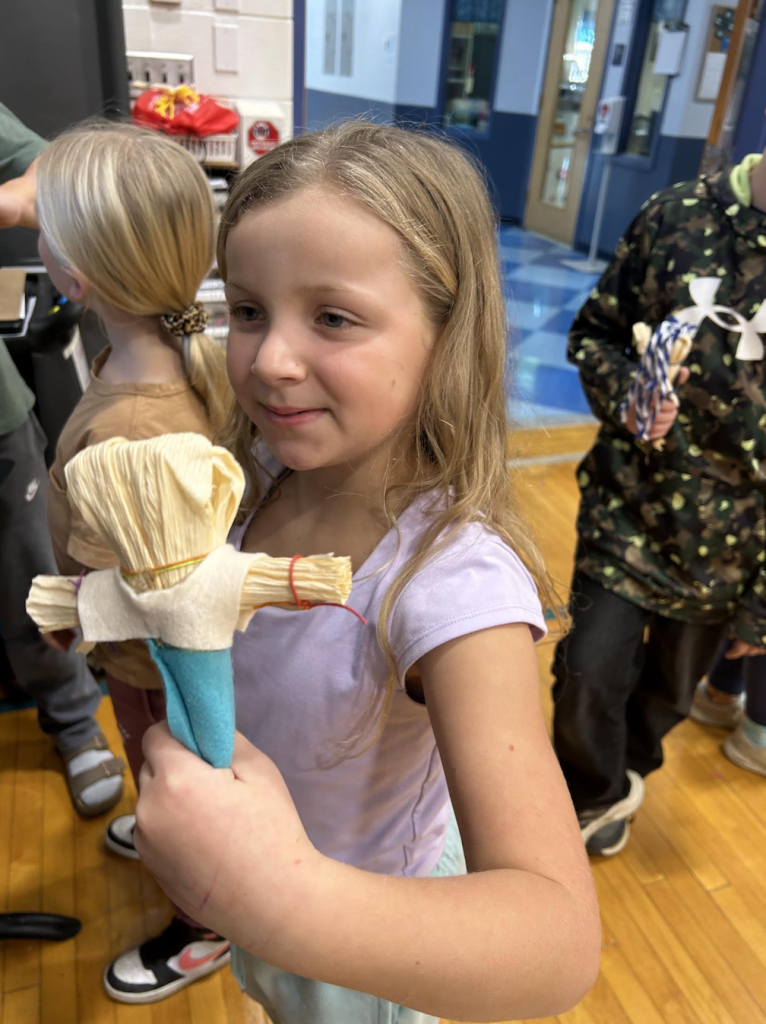 youth with a corn husk doll