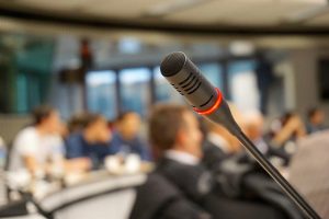 microphone at a conference with an audience in the background
