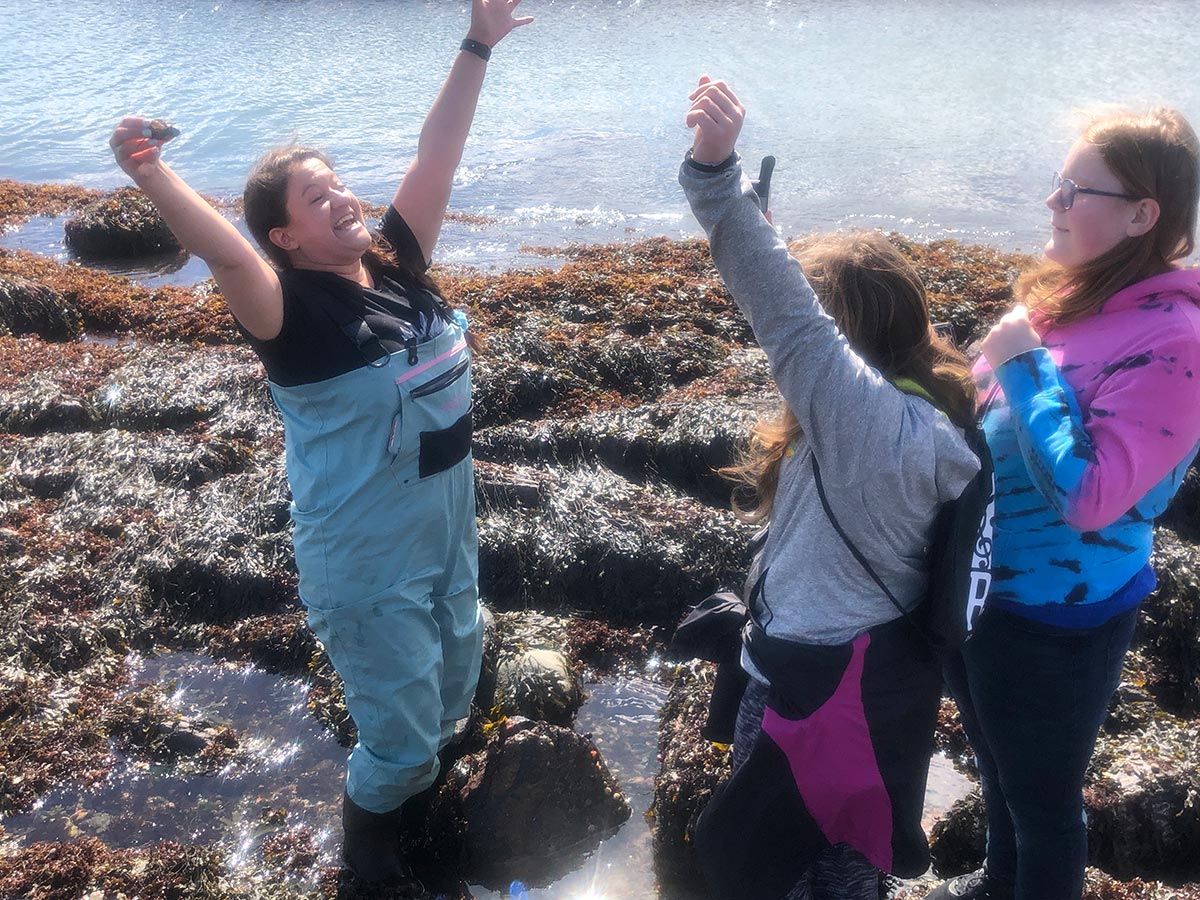 teenaged members of 4-H on the beach investigating sealife on the shore