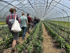 Photo of participants touring a greenhouse at Stonecipher Farm