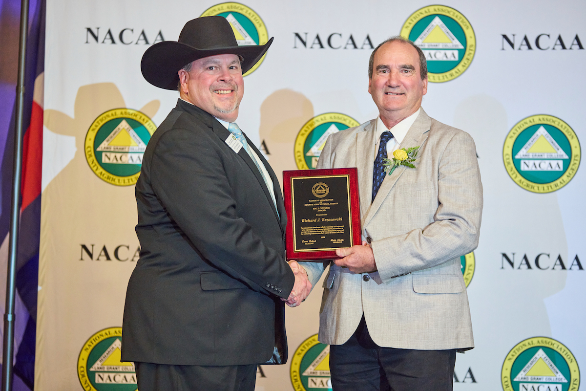 NACAA President Keith Mickler (Georgia) presents the NACAA 2024 Hall of Fame award to North East Region winner Richard Brzozowski, University of Maine Cooperative Extension Professor Emeritus