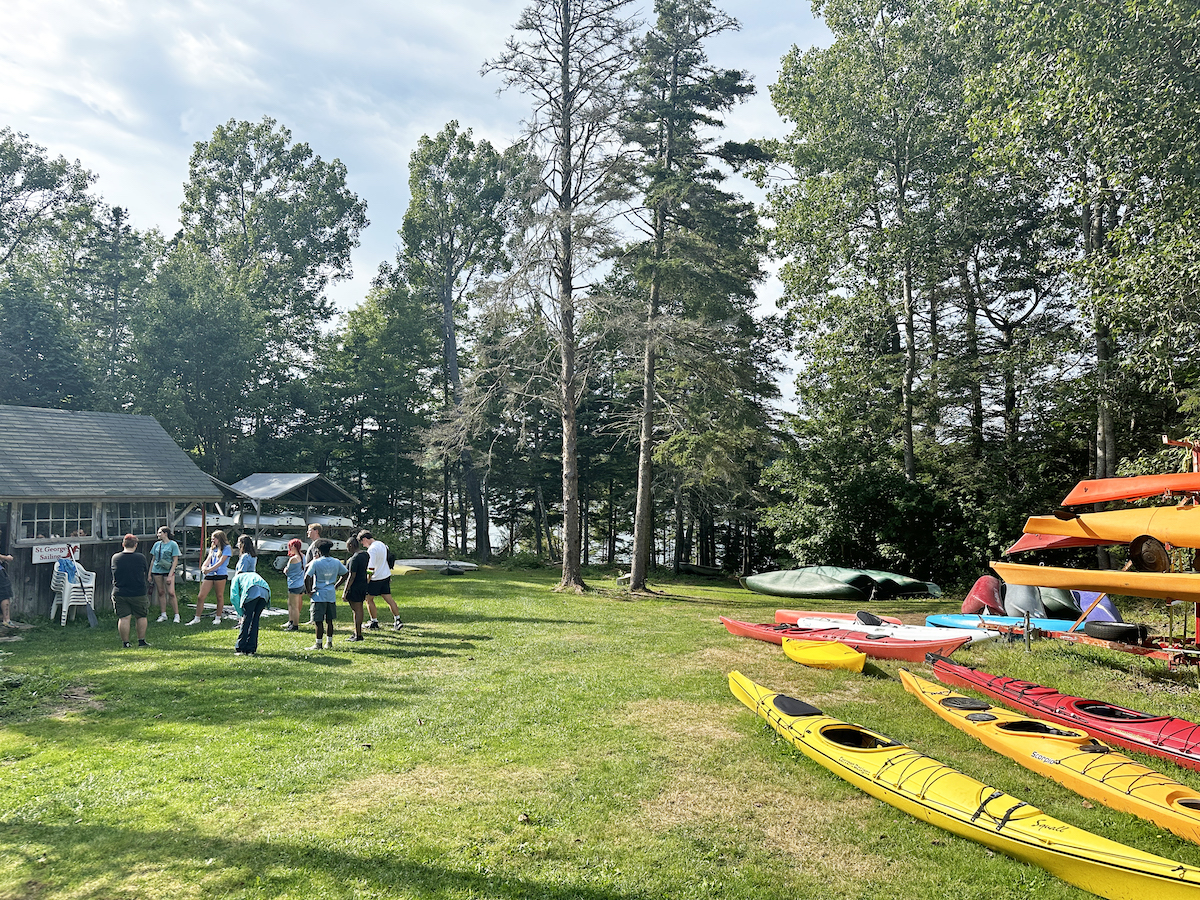 people and kayaks by the water at Blueberry Cove